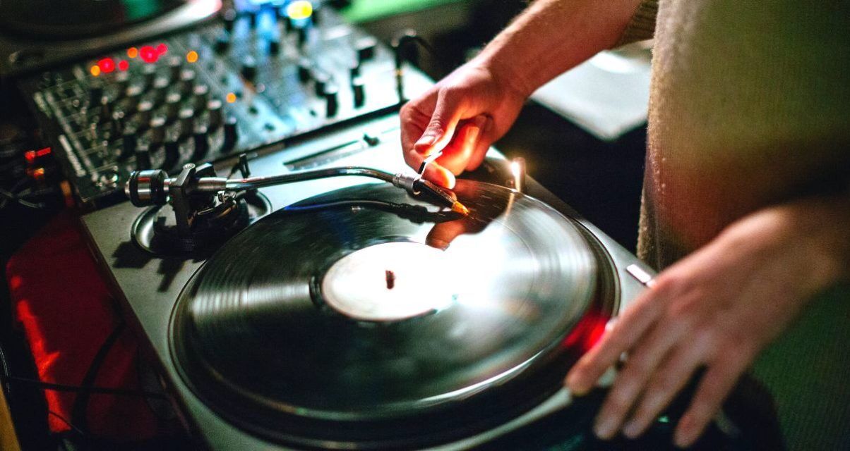 DJ puts needle on a record