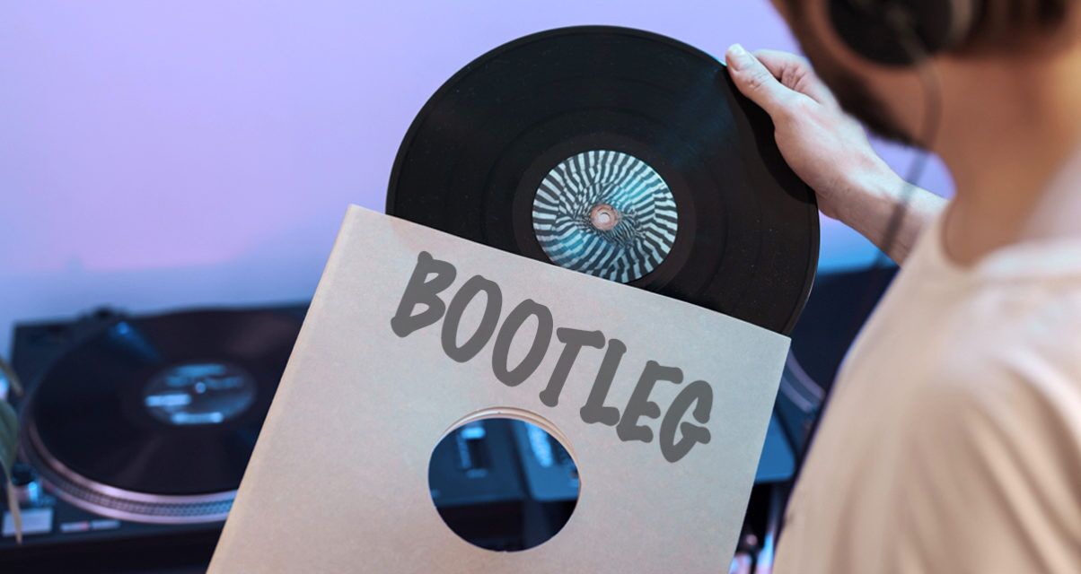 A bearded white man in his 30s stands facing a vinyl DJ set-up. He's taking a black record out of it's sleeve with his right hand. On the lightly coloured sleeve is the word "Bootleg" in big, bold letters.