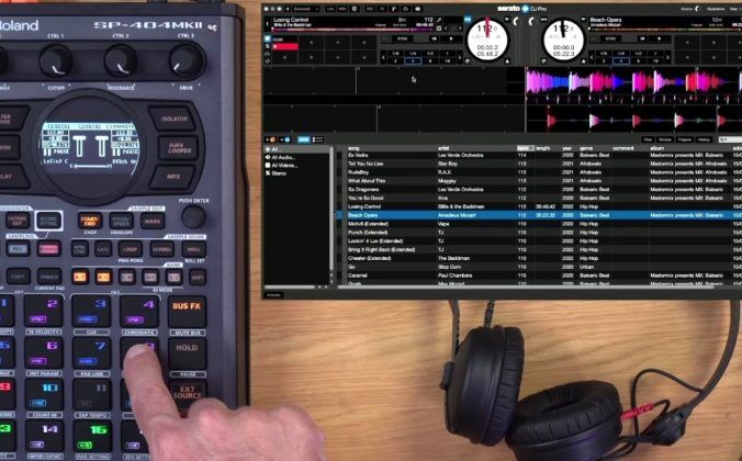 A dark grey Roland SP-404MKII device sits on a wooden table next to some black headphones and a silver laptop. A white person is pressing one of the buttons. In the top right is an image of Serato DJ Pro software.