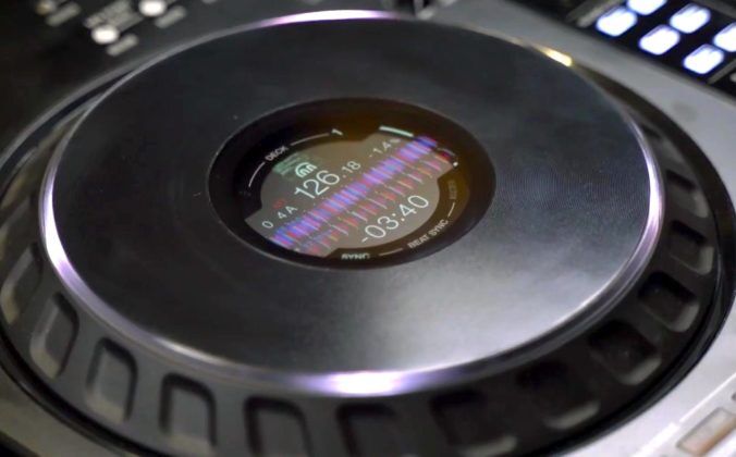 Close-up of a black Pioneer DJ DDJ-FLX10 on-jogwheel display, featuring Djay Pro's colourful waveforms plus tempo and track time indicators.