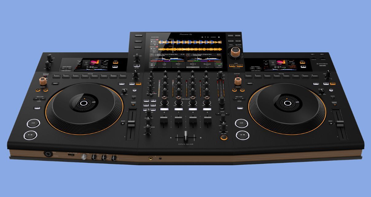 Top angled view of a black and brown Opus Quad standalone DJ system on a baby blue background